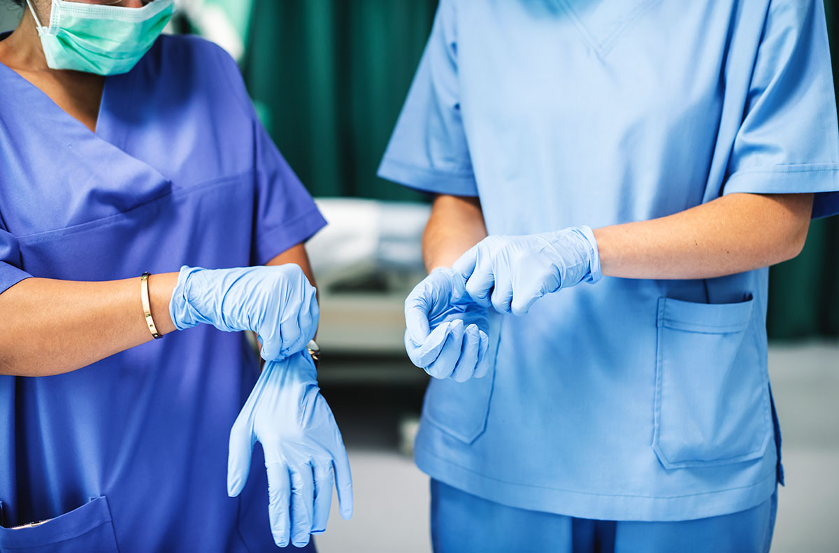 Healthcare workers putting on gloves